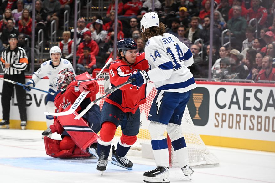 Washington Capitals forward Ryan Leonard (9) checking Tampa Bay Lightning center Conor Geekie (14) in front of the net during the second period of an NHL game at Capital One Arena in Washington D.C., October 14, 2025. (Photo for the Washington Times)