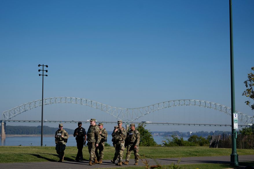 Members from the 117th Military Police Battalion of the National Guard and a Memphis Police Department officer conduct a community safety patrol at Tom Lee Park, Sunday, Oct. 12, 2025, in Memphis, Tenn. (AP Photo/George Walker IV)