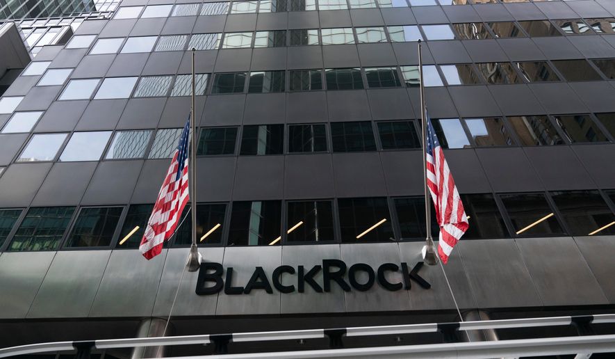 FILE -Flags fly on the front of BlackRock headquarters, Wednesday, Jan. 13, 2021, in New York. . (AP Photo/Mark Lennihan, File)