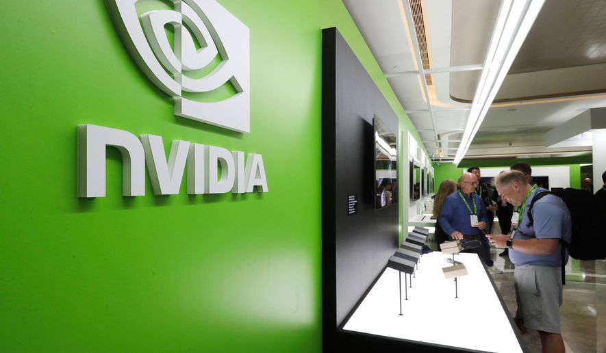 People take a look at Nvidia's new products during the Computex 2025 exhibition in Taipei, Taiwan, Wednesday, May 21, 2025. (AP Photo/Chiang Ying-ying, File)