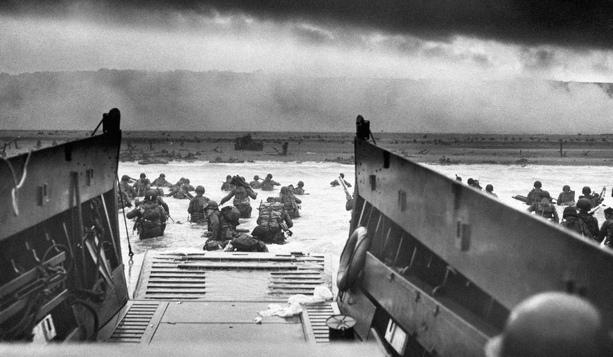 FILE - This photograph is believed to show E Company, 16th Regiment, 1st Infantry Division, participating in the first wave of assaults during D-Day in Normandy, France, June 6, 1944. (Chief Photographer's Mate Robert M. Sargent, U.S. Coast Guard via AP, File)