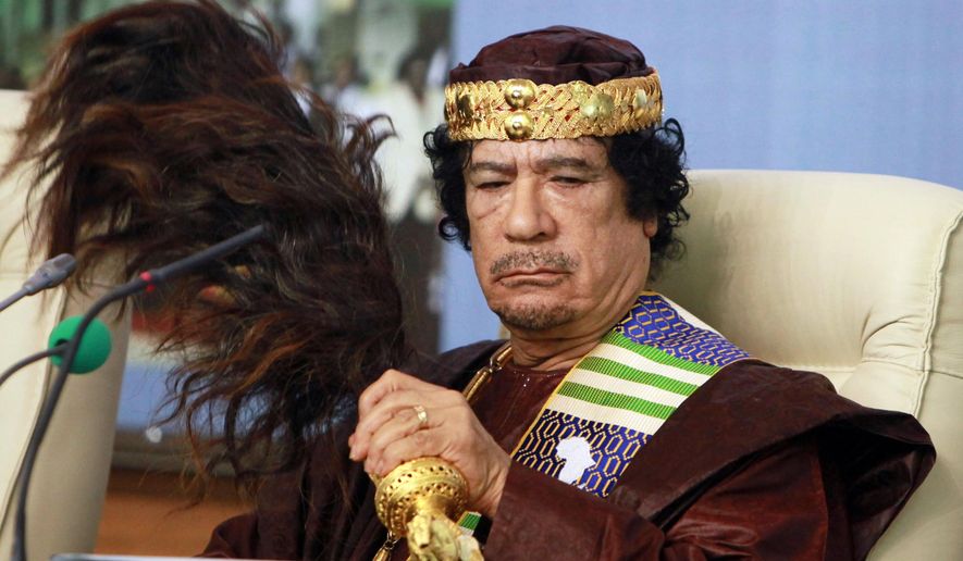 FILE - Libyan leader Moammar Gadhafi fans his face during the Forum of Kings, Princes, Sultans, Sheikhs and Mayors of Africa in Tripoli on Sept. 8 2010. (AP Photo/Abdel Magid Al Fergany, File)