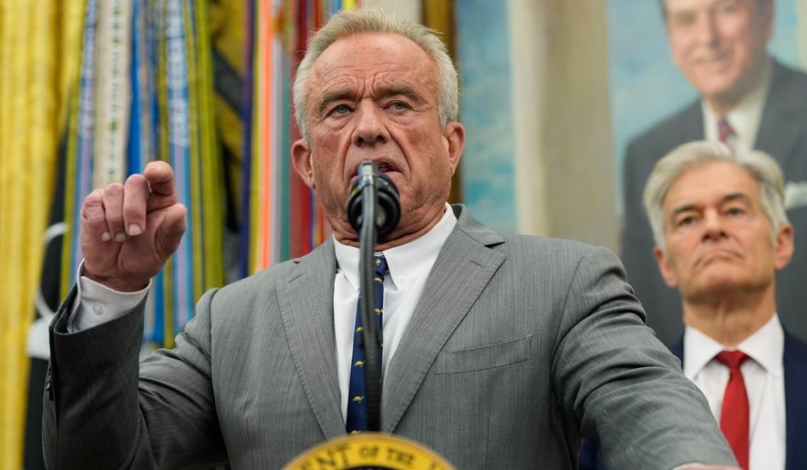 Health and Human Services Secretary Robert F. Kennedy Jr. speaks as Centers for Medicare & Medicaid Services administrator Dr. Mehmet Oz listens during an event with President Donald Trump in the Oval Office of the White House, Friday, Oct. 10, 2025, in Washington. (AP Photo/Alex Brandon)