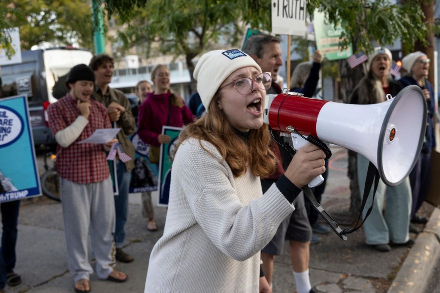 University of Montana student Maddie Grebb leads a chant across the street from the Russell Smith federal courthouse, where young climate activists were in court challenging President Donald Trump's orders promoting fossil fuels, Sept. 17, 2025, in Missoula, Montana. (Ben Allan Smith/The Missoulian via AP)