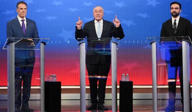 Republican candidate Curtis Sliwa, center, speaks during a mayoral debate with independent candidate former New York Gov. Andrew Cuomo, left, and Democratic candidate Zohran Mamdani, Thursday, Oct. 16, 2025, in New York. (AP Photo/Angelina Katsanis, Pool)