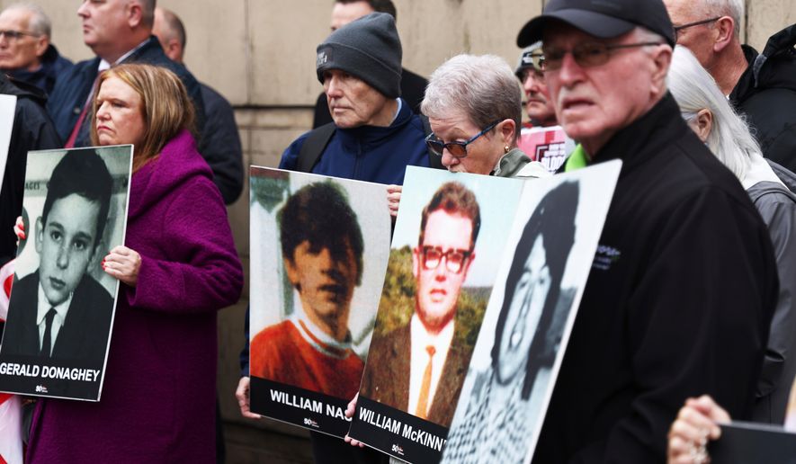 FILE - Families of the victims of the 1972 Bloody Sunday, hold a protest outside Belfast Crown court, Northern Ireland, Monday Sept. 15, 2025. (AP Photo/Peter Morrison, File)