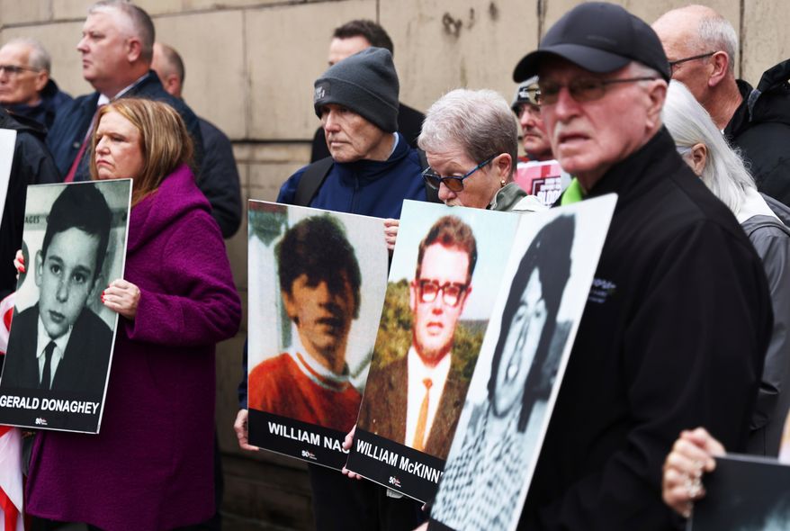 FILE - Families of the victims of the 1972 Bloody Sunday, hold a protest outside Belfast Crown court, Northern Ireland, Monday Sept. 15, 2025. (AP Photo/Peter Morrison, File)