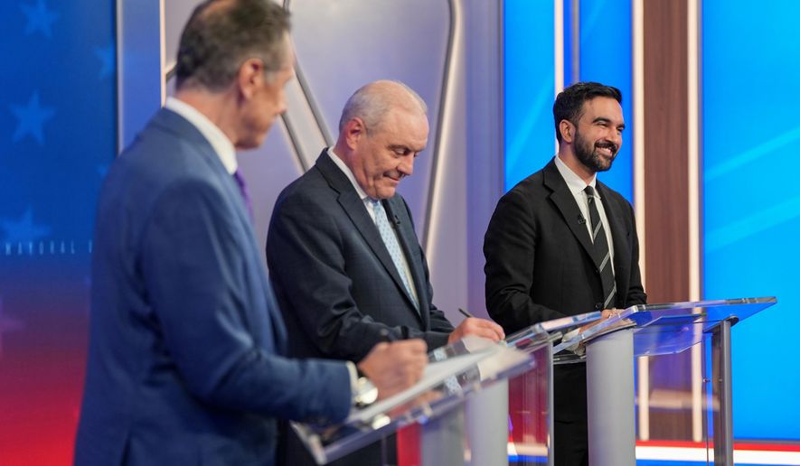 From left, Mayoral candidates Independent candidate former New York Gov. Andrew Cuomo, Republican candidate Curtis Sliwa and Democratic candidate Zohran Mamdani participate in a mayoral debate, Thursday, Oct. 16, 2025, in New York. (AP Photo/Angelina Katsanis, Pool)