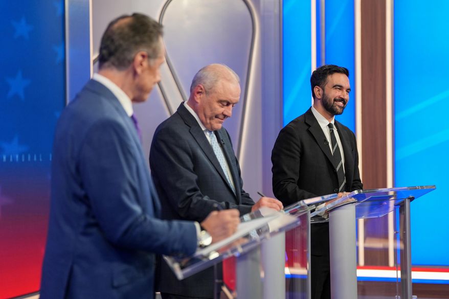 From left, Mayoral candidates Independent candidate former New York Gov. Andrew Cuomo, Republican candidate Curtis Sliwa and Democratic candidate Zohran Mamdani participate in a mayoral debate, Thursday, Oct. 16, 2025, in New York. (AP Photo/Angelina Katsanis, Pool)