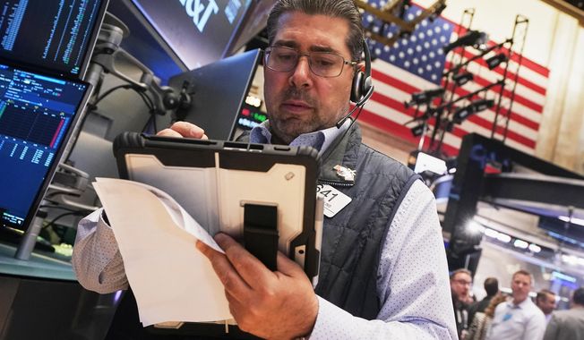 Trader Michael Capolino works on the floor of the New York Stock Exchange, Wednesday, Oct. 15, 2025. (AP Photo/Richard Drew)