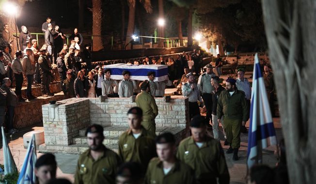 Israeli soldiers carry the coffin of slain hostage Capt. Daniel Peretz during his funeral at Mount Herzl military cemetery in Jerusalem, Wednesday, Oct. 15, 2025. Peretz's body was returned from Gaza to Israel as part of a ceasefire agreement between Israel and Hamas. (AP Photo/Francisco Seco)