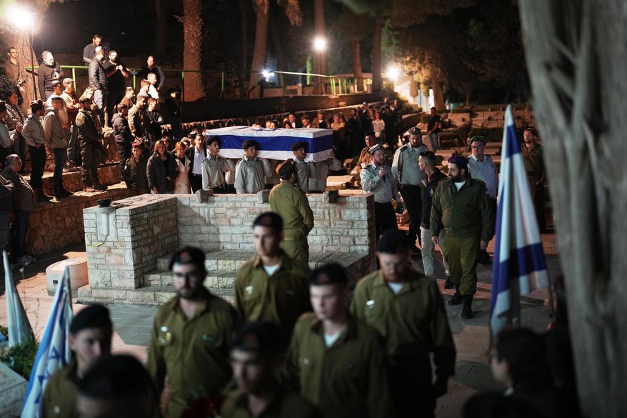 Israeli soldiers carry the coffin of slain hostage Capt. Daniel Peretz during his funeral at Mount Herzl military cemetery in Jerusalem, Wednesday, Oct. 15, 2025. Peretz's body was returned from Gaza to Israel as part of a ceasefire agreement between Israel and Hamas. (AP Photo/Francisco Seco)