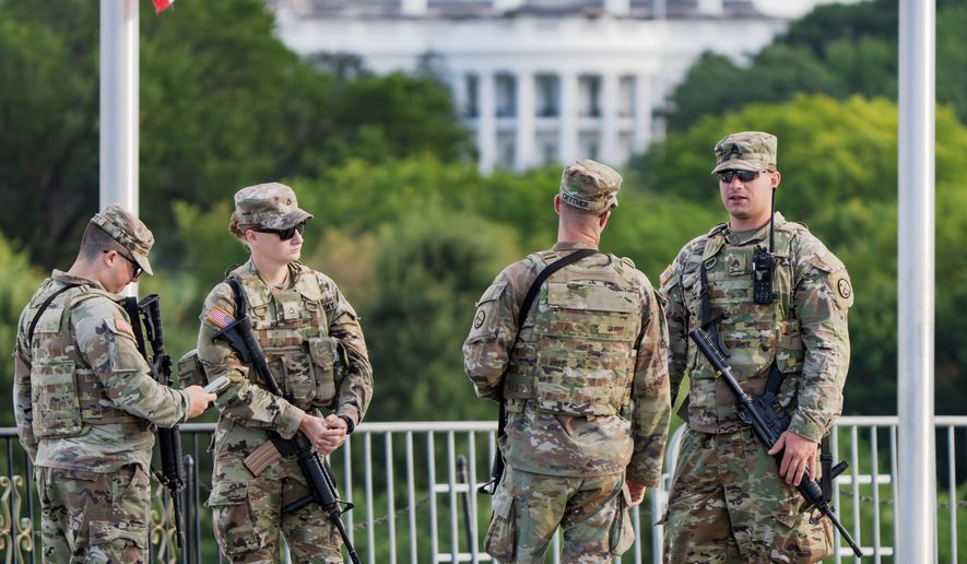 With the White House in the distance, National Guard troops patrol the Mall as part of President Donald Trump's order to impose federal law enforcement in the nation's capital, in Washington, Aug. 28, 2025. (AP Photo/J. Scott Applewhite, File)