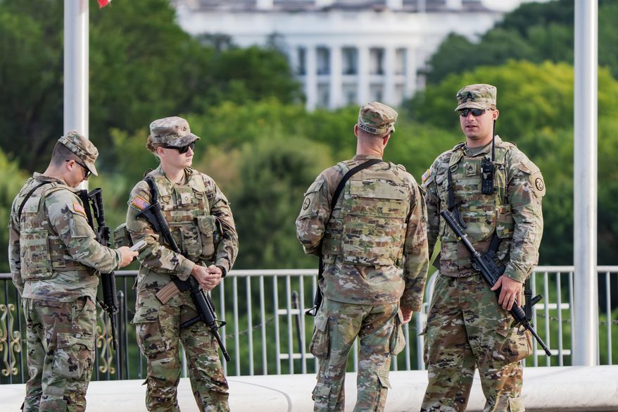 With the White House in the distance, National Guard troops patrol the Mall as part of President Donald Trump's order to impose federal law enforcement in the nation's capital, in Washington, Aug. 28, 2025. (AP Photo/J. Scott Applewhite, File)