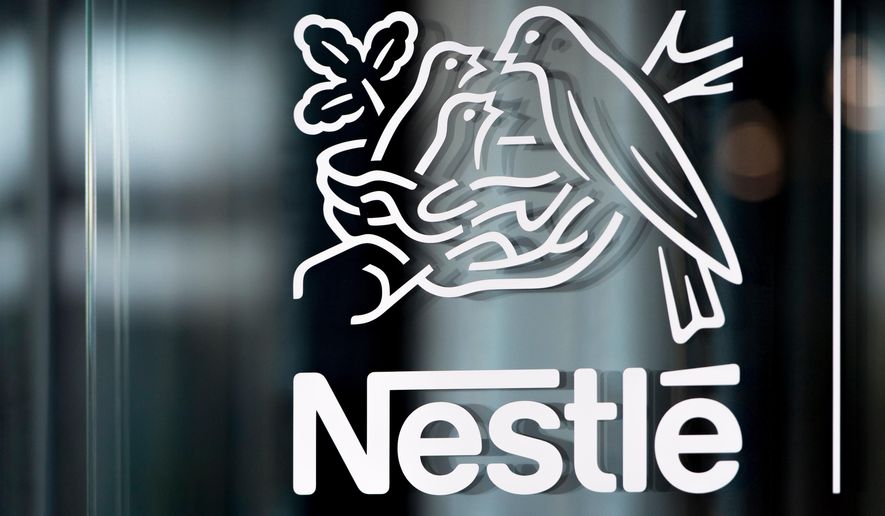 FILE - In this Thursday, Feb. 14, 2019, file photo, Nestle's logo is displayed on a window, during the 2018 full-year results press conference of the food and drinks giant Nestle, in Vevey. (Laurent Gillieron/Keystone via AP, File)