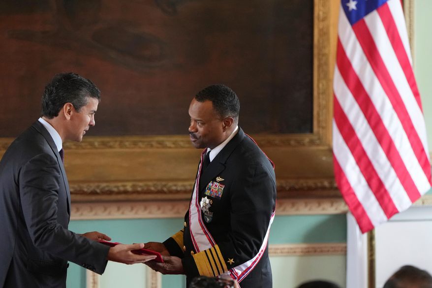 Paraguay's President Santiago Peña awards the Order of Merit "Gral Div Bernardino Caballero" in the grade of "Gran Cross", to Navy Adm. Alvin Holsey, commander of US Southern Command, at Government Palace in Asuncion, Paraguay, Aug. 23, 2025. (AP Photo/Jorge Saenz, File)