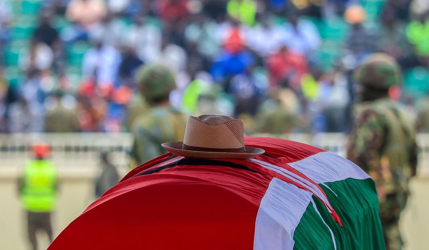 A signature cowboy hat that former Kenya Prime Minister Raila Odinga loved to wear lies on top of his coffin during his state funeral at Nyayo National Stadium in Nairobi, Kenya, Friday, Oct. 17, 2025. (AP Photo/Andrew Kasuku)