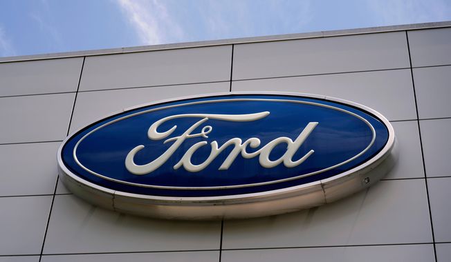 FILE - The Ford logo is seen above the entrance to the Ford Motor Company Kentucky Truck Plant, Wednesday, April 30, 2025, in Louisville, Ky. (AP Photo/Carolyn Kaster, File)