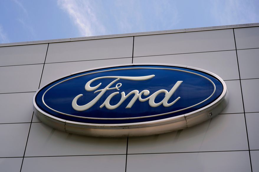 FILE - The Ford logo is seen above the entrance to the Ford Motor Company Kentucky Truck Plant, Wednesday, April 30, 2025, in Louisville, Ky. (AP Photo/Carolyn Kaster, File)