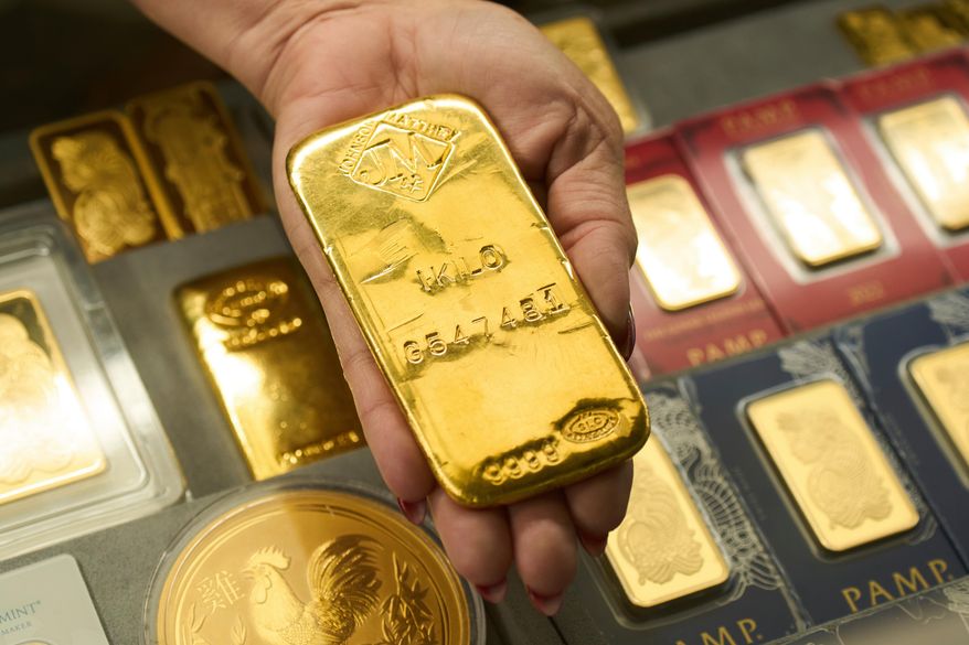 FILE - Sam Nguyen shows a gold bar at her shop in the St. Vincent Jewelry Center in the Jewelry District of Los Angeles, Wednesday, April 30, 2025. (AP Photo/Jae C. Hong, File)