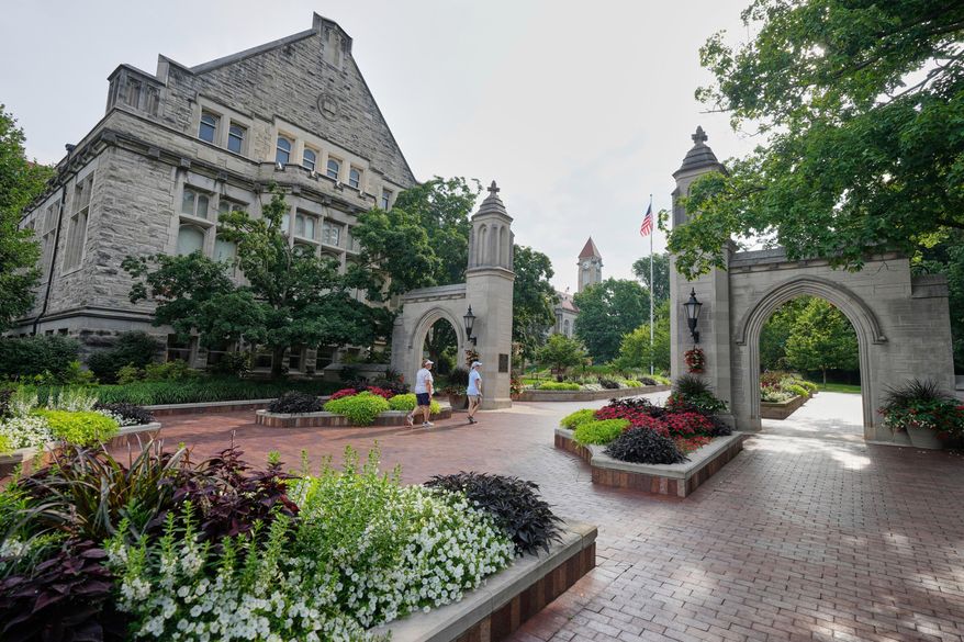 Guests walk on the campus of Indiana University, Thursday, July 17, 2025, in Bloomington, Ind. (AP Photo/Darron Cummings, File)