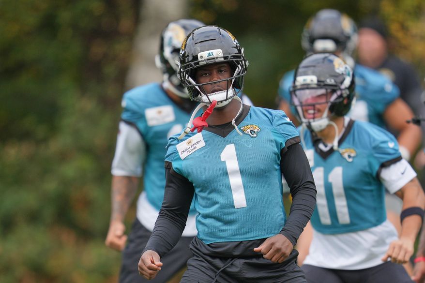 Jacksonville Jaguars running back Travis Etienne (1), works out during an NFL football practice at The Grove in Watford, England, Friday, Oct. 17, 2025. (AP Photo/Kin Cheung)