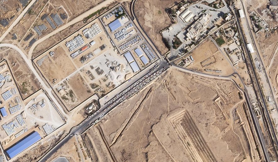 This satellite photo from Planet Labs PBC shows trucks lined up on the Egyptian side of the Rafah border crossing with the Gaza Strip on Thursday, Oct. 16, 2025. (Planet Labs PBC via AP)