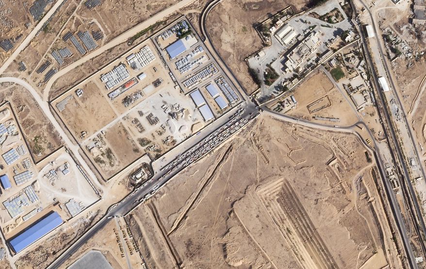 This satellite photo from Planet Labs PBC shows trucks lined up on the Egyptian side of the Rafah border crossing with the Gaza Strip on Thursday, Oct. 16, 2025. (Planet Labs PBC via AP)