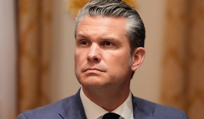 Defense Secretary Pete Hegseth listens as President Donald Trump speaks before a lunch with Ukraine's President Volodymyr Zelenskyy in the Cabinet Room of the White House, Friday, Oct. 17, 2025, in Washington. (AP Photo/Alex Brandon)