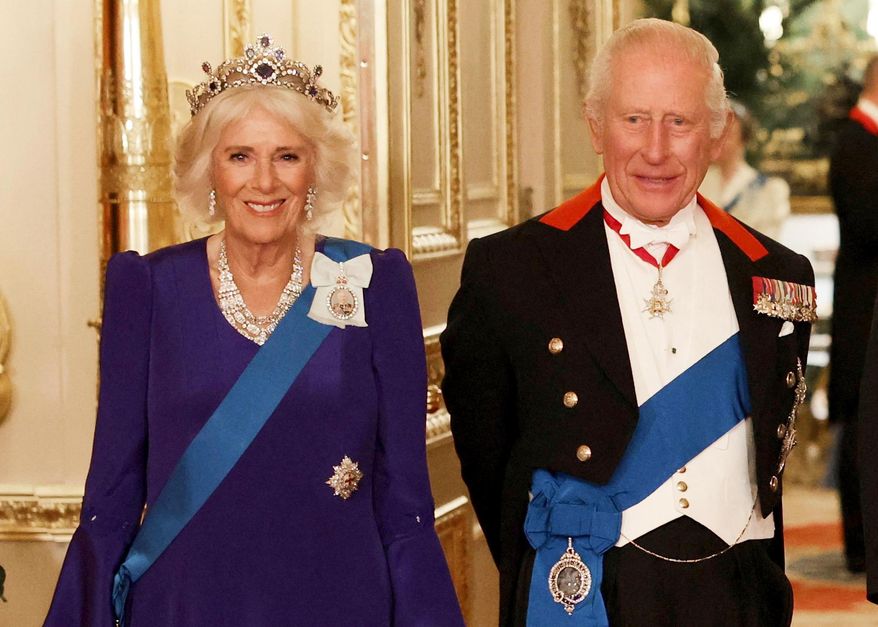 Britain's Queen Camilla, left, and King Charles III, right, pose for a photo before a State Banquet at Windsor Castle, in Windsor, England, Sept. 17, 2025. (Phil Noble/Pool Photo via AP, file)