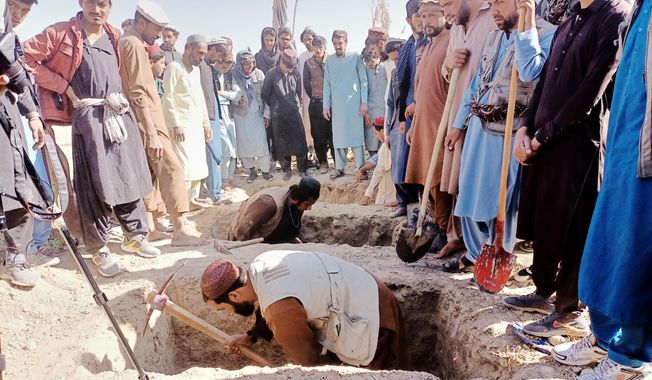 Locals dig graves for people killed in a cross-border airstrike by the Pakistani army in Afghanistan's eastern Paktika province, Saturday, Oct. 18, 2025. (AP Photo/Shafiqullah Mashaal)