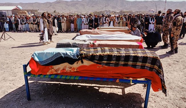 The bodies of victims of a Pakistani cross-border airstrike, including three local cricketers, are prepared for their funeral in the village of Khandaro in the Argun district of Afghanistan's eastern Paktika province, Saturday, Oct. 18, 2025. (AP Photo/Shafiqullah Mashaal)