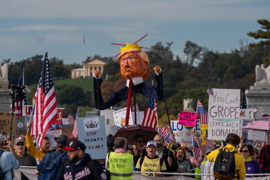 Crowds gather for a No Kings protest, Saturday, Oct. 18, 2025, in Washington. (AP Photo/Allison Robbert)
