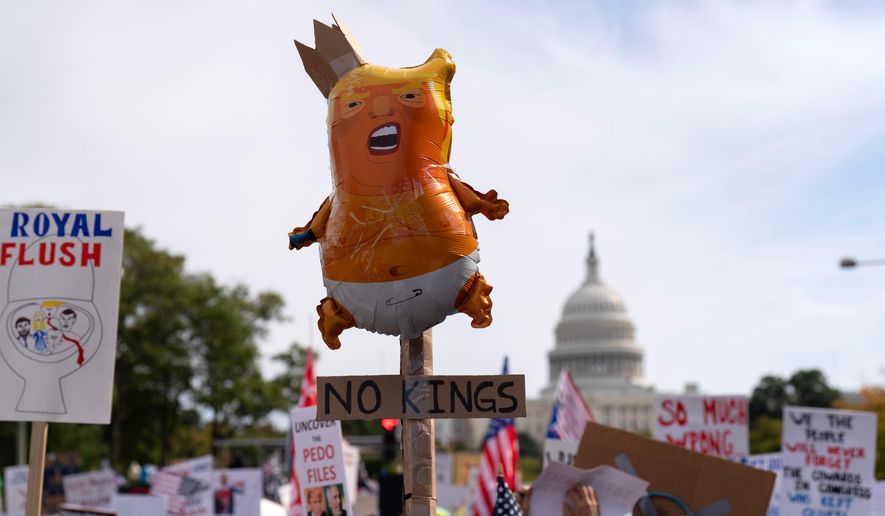 Demonstrators rally on Pennsylvania Avenue during a No Kings protest in Washington, Saturday, Oct. 18, 2025. (AP Photo/Jose Luis Magana)