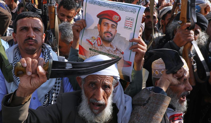 Houthi supporters hold a poster of Maj. Gen. Muhammad Abdul Karim al-Ghamari, who died of wounds he suffered after an Israeli attack, during an anti-U.S. and anti-Israel rally in Sanaa, Yemen, Friday, Oct. 17, 2025. (AP Photo/Osamah Abdulrahman)