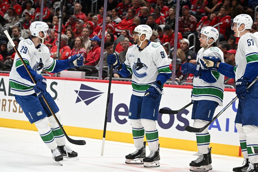 Vancouver Canucks forward Evander Kane (91) celebrating with teammates after scoring a goal during the second period of an NHL game against the Washington Capitals at Capital One Arena in Washington D.C., October 19, 2025. (Photo for the Washington Times)