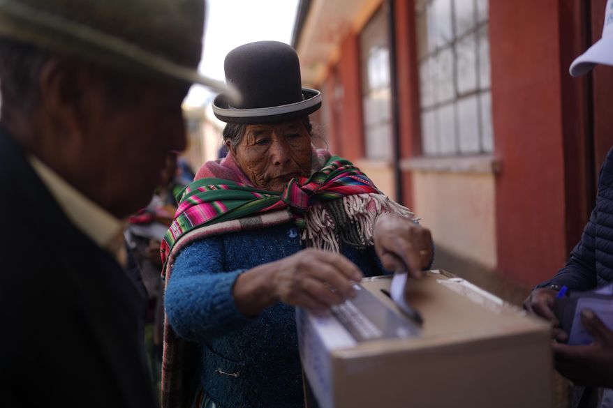 A voter casts her ballot in a presidential runoff election in Warisata, Bolivia, Sunday, Oct. 19, 2025. (AP Photo/Juan Karita)