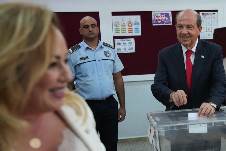 Turkish Cypriot candidate and leader Ersin Tatar, right, and his wife Sibel, cast their ballots at a polling station during the Turkish Cypriots election for a new leader in the Turkish occupied area in the north part of the divided capital Nicosia, Cyprus, Sunday, Oct. 19, 2025. (AP Photo/Petros Karadjias)