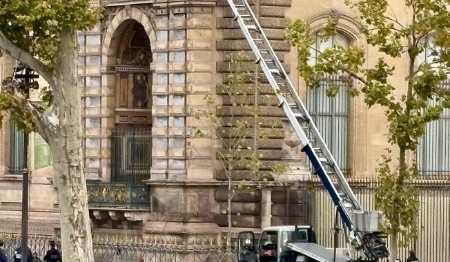 A basket lift used by thieves is seen at the Louvre museum Sunday Oct.19, 2025 in Paris. (AP Photo/Alexander Turnbull)