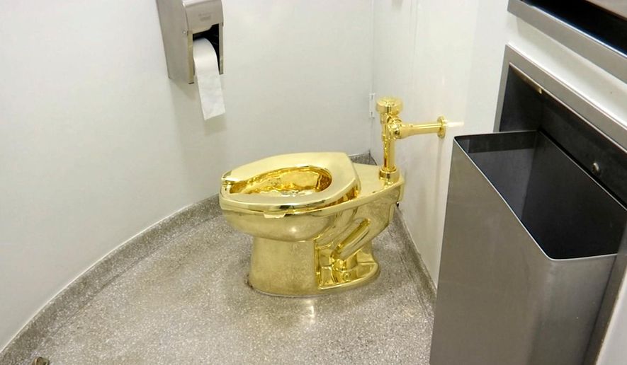 This Sept. 16, 2016 file image made from a video shows the 18-karat toilet, titled "America," by Maurizio Cattelan in the restroom of the Solomon R. Guggenheim Museum in New York. (AP Photo, File)