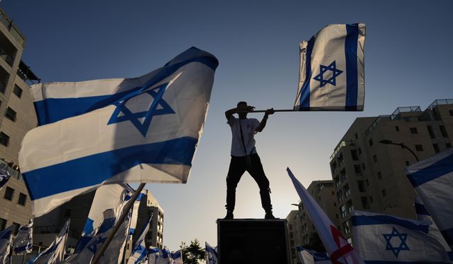 People gather to welcome freed Israeli hostage, Elkana Bohbot, who was recently released from Hamas captivity in Gaza, as he returns home from the hospital to Mevaseret Zion, Israel, Sunday, Oct. 19, 2025. (AP Photo/Francisco Seco)