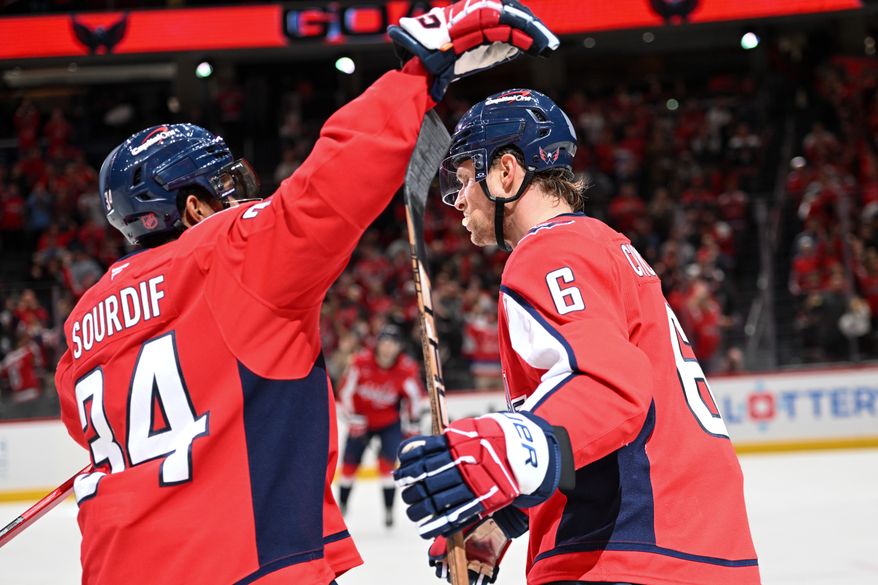 Washington Capitals defenseman Jakob Chychrun (6) being greeted by teammate Justin Sourdif (34) after scoring a goal during the third period of an NHL game against the Vancouver Canucks at Capital One Arena in Washington D.C., October 19, 2025. (Photo for the Washington Times)