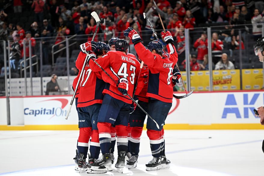 Washington Capitals players celebrate after John Carlson’s goal during the third period of an NHL game against the Vancouver Canucks at Capital One Arena in Washington D.C., October 19, 2025. (Photo for the Washington Times)