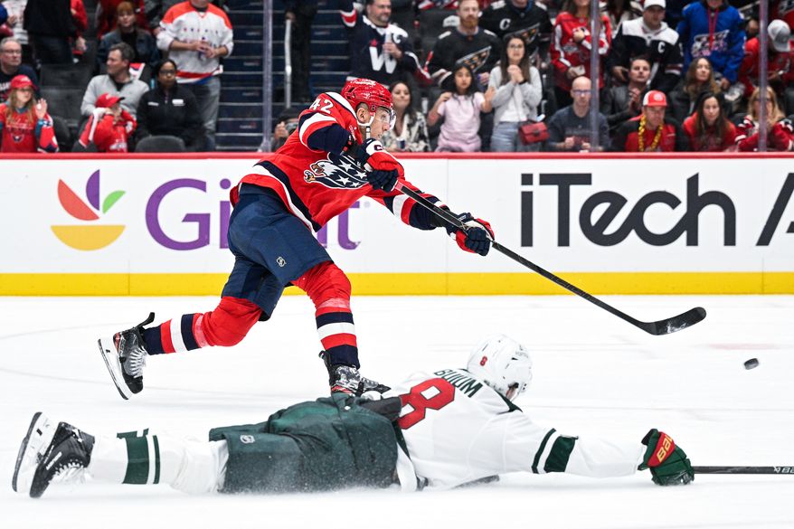 Washington Capitals defenseman Martin Fehervary (42) skates past Minnesota Wild defenseman Zeev Buium (8) and snaps a shot on net during the third period at Capital One Arena, Washington, D.C., October 17, 2025. (Photo by Brian Murphy for the Washington Times)