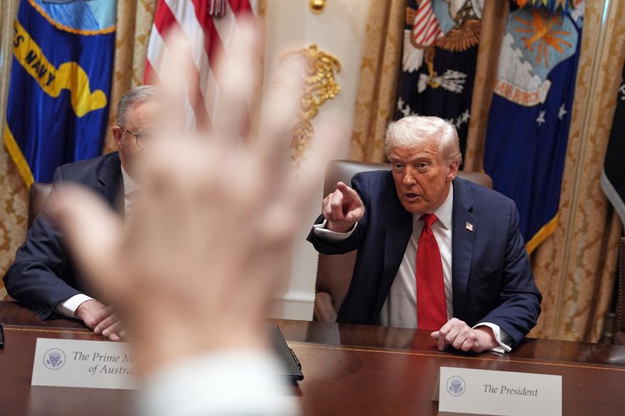 President Donald Trump, right, points as reporters raise their hands to ask questions during a meeting with Australian Prime Minister Anthony Albanese, obstructed at left, in the Cabinet Room of the White House in Washington on Monday, October 20, 2025. (AP Photo/Evan Vucci) **FILE**