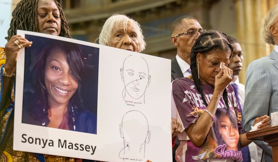 FILE - Donna Massey, center right, wipes tears from her face as she listens to Rev. Al Sharpton, right, speak during a press conference over the shooting death of her daughter Sonya, who was killed by Illinois sheriff's deputy Sean Grayson, at New Mount Pilgrim Church in the Garfield Park neighborhood in Chicago, Tuesday, July 30, 2024. (Tyler Pasciak LaRiviere/Chicago Sun-Times via AP, file)