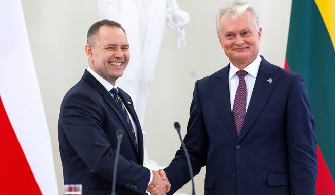 FILE - Polish President Karol Nawrocki, left, shakes hands with Lithuania's President Gitanas Nauseda after a joint press conference at the President's palace in Vilnius, Lithuania, Monday, Sept. 8, 2025. (AP Photo/Mindaugas Kulbis, file)