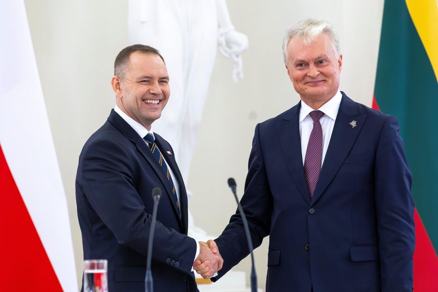 FILE - Polish President Karol Nawrocki, left, shakes hands with Lithuania's President Gitanas Nauseda after a joint press conference at the President's palace in Vilnius, Lithuania, Monday, Sept. 8, 2025. (AP Photo/Mindaugas Kulbis, file)