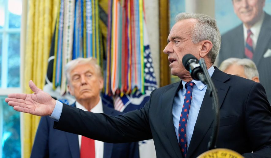 Secretary of Health and Human Services Robert F. Kennedy Jr. speaks in the Oval Office of the White House, Tuesday, Sept. 30, 2025, in Washington, as President Donald Trump looks on. (AP Photo/Alex Brandon) **FILE**