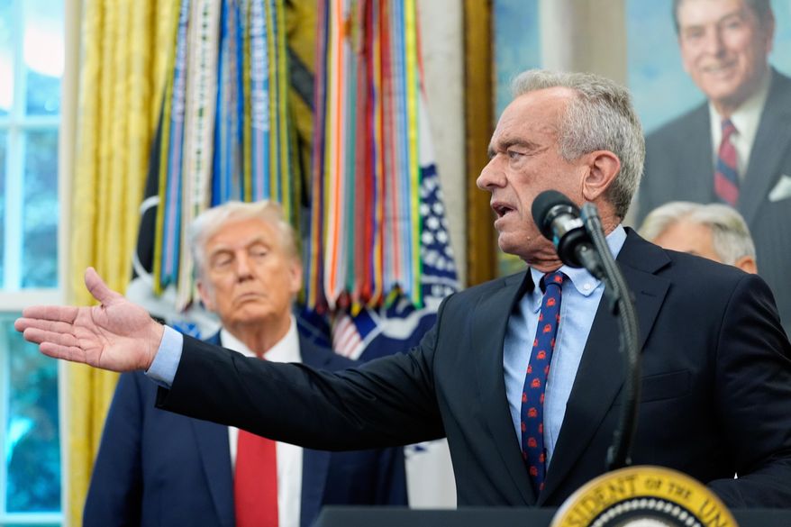 Secretary of Health and Human Services Robert F. Kennedy Jr. speaks in the Oval Office of the White House, Tuesday, Sept. 30, 2025, in Washington, as President Donald Trump looks on. (AP Photo/Alex Brandon) **FILE**